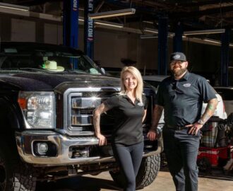 Legacy Auto Clinic Castle Rock co-owners pose outside repair bays