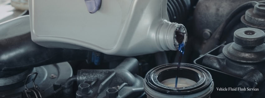mechanic pouring fluid into vehicle Legacy Auto Clinic Castle Rock 